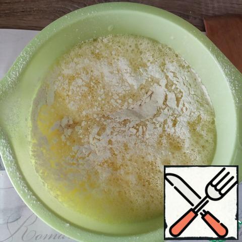 Gradually add the sifted flour, starch, soda (quenched with vinegar or lemon).