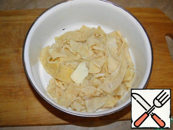 Add butter to the noodles and mix.