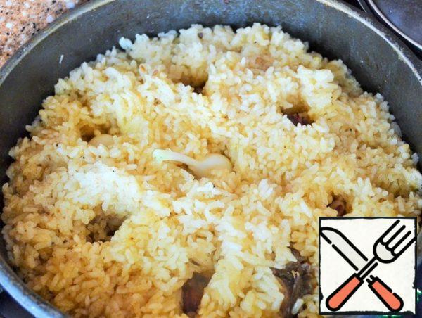 After 15 minutes, spread the rice cloves garlic,
cover and leave on heat for another 5-7 minutes.
