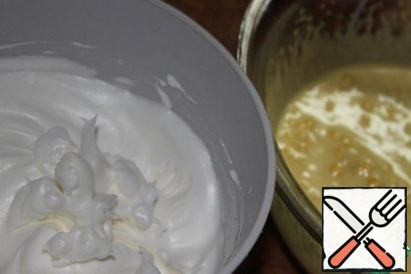 Separate the yolks from the whites. Whisk the whites with a pinch of salt, then gradually adding 1/5 of the sugar, until peaks form. Whisk the yolks, add hot boiled water, vanilla sugar, remaining sugar, whisk until light.
