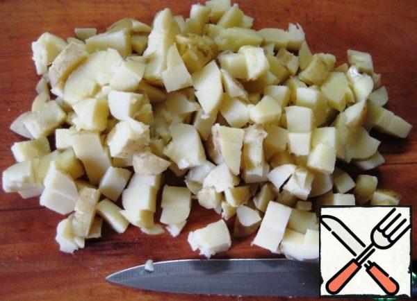 Boil potatoes, cut into cubes.
