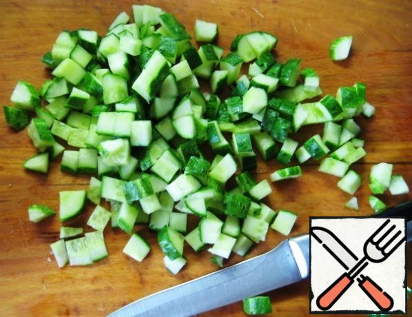 And cucumbers. Combine the chopped ingredients in a bowl.