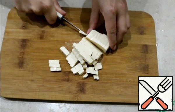 Cut the melted cheese into cubes.
