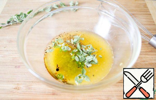 In the gathered orange juice add freshly ground black pepper, salt, olive oil, balsamic vinegar and leaves torn from the stems of greenery.