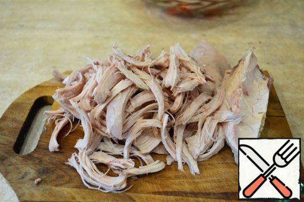 Boiled chicken breast tear hands on the fiber.