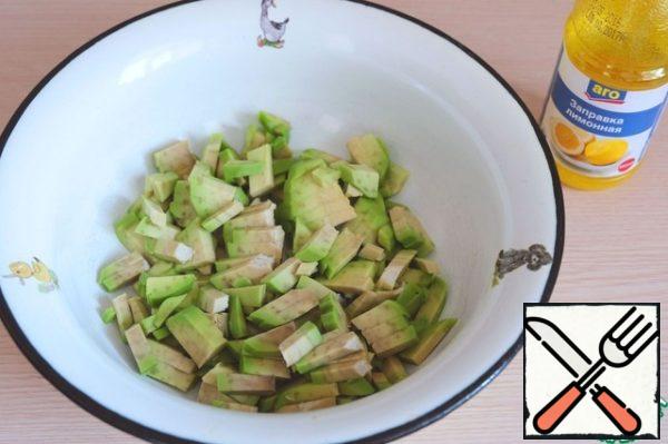 Cut avocado put in a bowl, add a tablespoon of lemon dressing or lemon juice. 