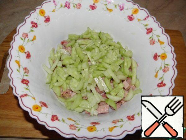 Peel cucumbers and cut into strips, add to the chicken.