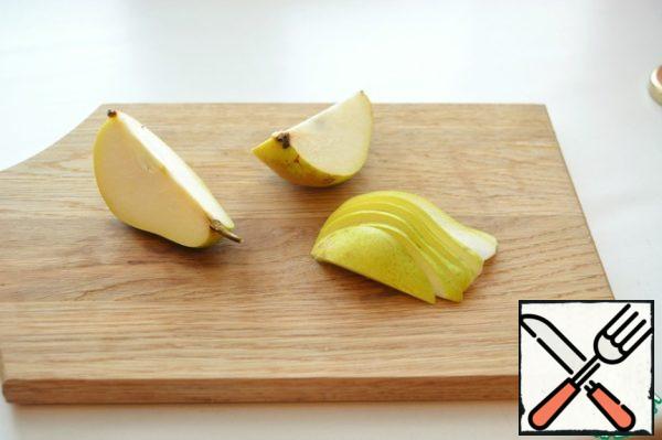 Ripe juicy pear cut into thin slices.