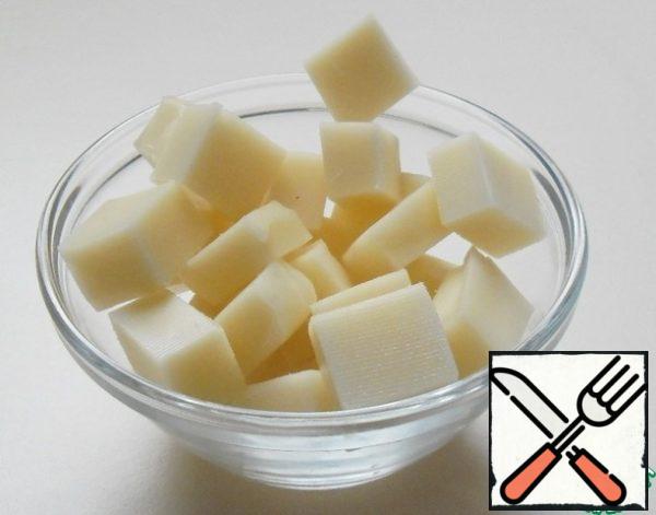 Cut the cheese into medium-sized cubes.
