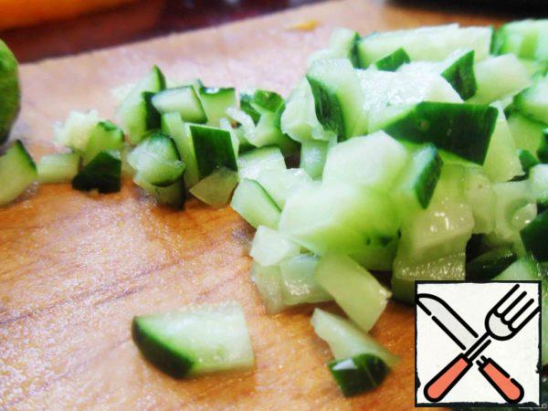 Cut cucumbers and carrots, add corn, combine with cabbage (by this time the proteins should be well colored).
