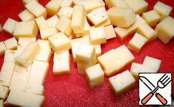Cheese cut into small cubes. Put into salad and mix.