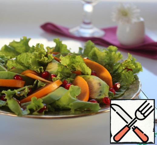 Vegetable bed of lettuce lay out alternating slices of avocado and persimmon. Sprinkle with pomegranate seeds and pour with dressing.
