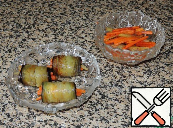 Ready vegetable stuffing wrapped in eggplant plates in the form of rolls.