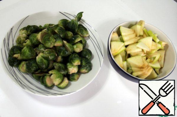 Heads of Brussels sprouts and my cut in half. Apple cut into small slices.