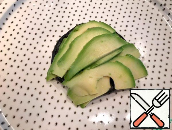 Put on a plate.
Cut the avocado into thin slices and place on the champignon.
Half an avocado for each hat.