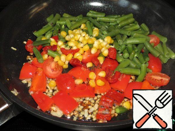Heat olive oil in a saucepan and fry finely chopped onion, pepper, cherry, dried tomatoes, beans in it until soft for 5 minutes over medium heat, stirring. Then add the basil, ground red pepper, salt and cook for another 5 minutes.
