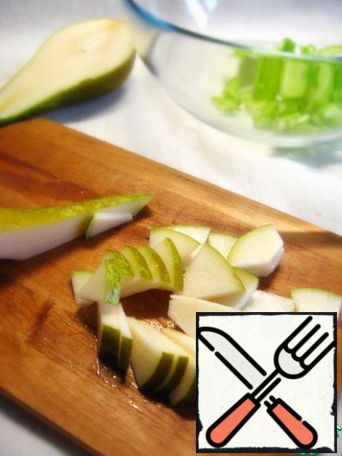 Slice the pear and add to the bowl.