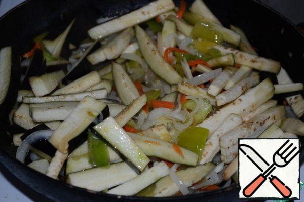 To the vegetables add the eggplant and fry until cooked eggplant.
