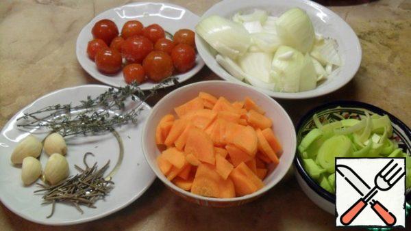 Carrots and onions to clear, cut into half rings, carrots can be rings, cubes. Wash leeks and also cut into rings. The cherry tomatoes can be taken fresh or frozen, the number roughly 4 pieces per serving, if desired, can be increased. Peel the garlic.