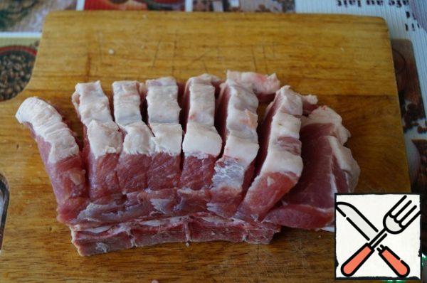 Take the lumbar part of pork, wash, dry with a napkin or towel. I have a meat with bone, but can be cooked and boneless part. Cut in pieces 1 cm thick, not cutting through meat until the end (if boneless) or cutting to the bone, as I have.