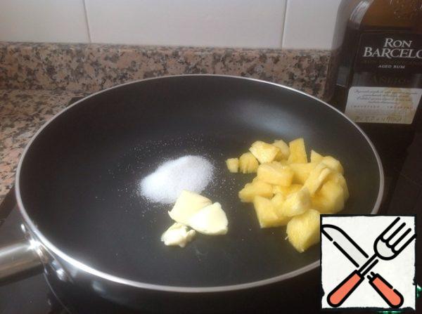 1 tablespoon of butter, 1 tablespoon of sugar and pieces of pineapple heat in a frying pan over medium heat until sugar dissolves.