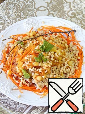 Form a salad. On a dish spread carrots, barley on it, apples on top. Sprinkle with nuts, pour lemon juice and garnish with mint. Salad's ready.
