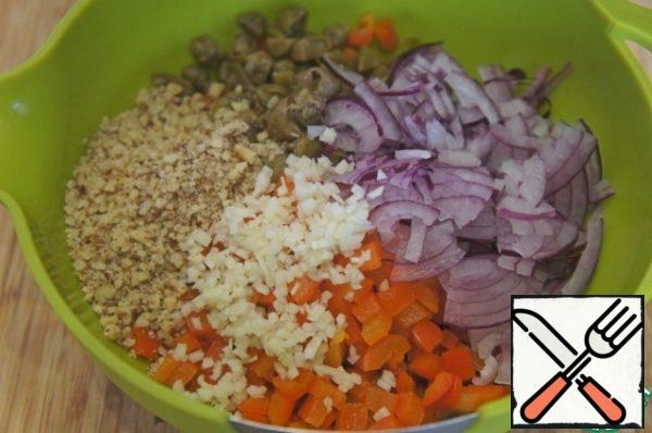 Add capers, onion, garlic and nuts.
