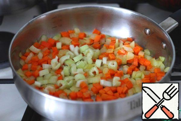 Next, add the chopped celery stalk, simmer the mixture until Al dente carrots.