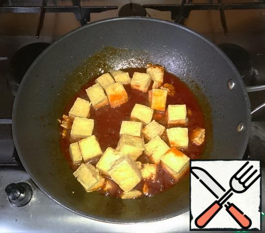 Add the fried tofu. Mix well so that the sauce covers all the pieces.