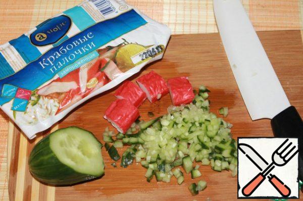 Cucumber cut into small cubes, crab sticks into 4 pieces across.