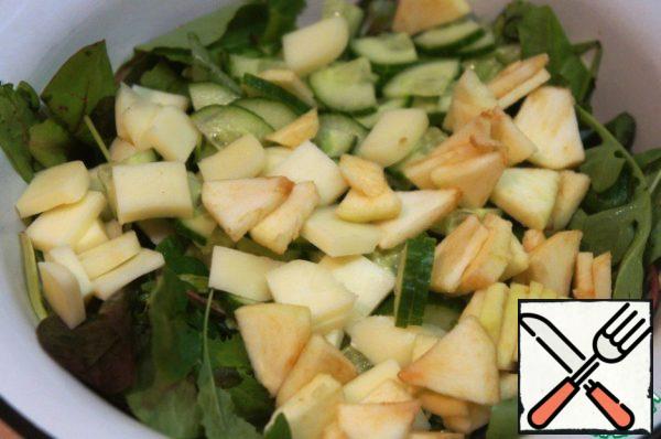 Pour the salad mixture into a wide bowl, add cucumbers, cheese and apple and mix gently.
