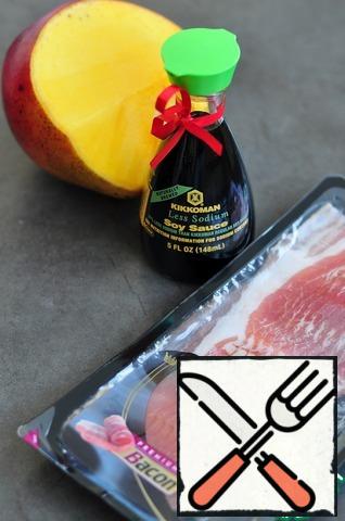 Peel the mango and wrap it in a strip of bacon.