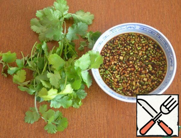 Finely chop the peeled ginger, garlic and cilantro cuttings, put them in a bowl and add soy sauce and lime juice.
