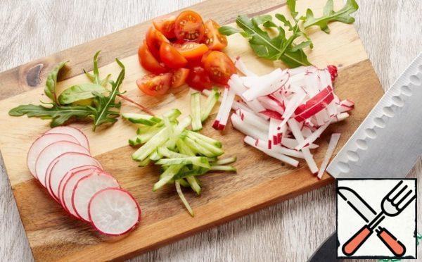 Cut the cherry into quarters, cut the cucumber and radish into strips.
Put the salad mixture in a deep bowl. Add chopped cherry quarters and cucumber with radish to the salad mixture.
