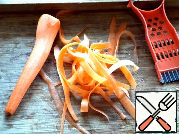 Carrots with a peeler cut into thin ribbons.