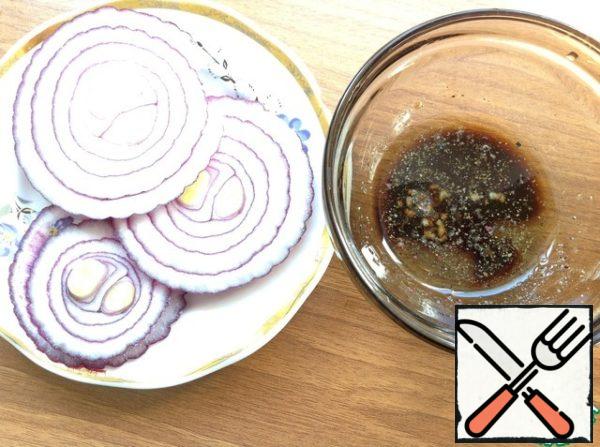 Onion cut into thin rings. Make the dressing: mix the oil, soy sauce and garlic passed through a press. Add ground pepper, stir.