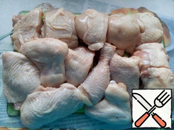 Wash the chicken, dry with paper towels and cut into portions.
