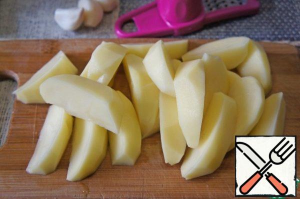 Cut peeled potatoes into quarters. Crush the garlic.