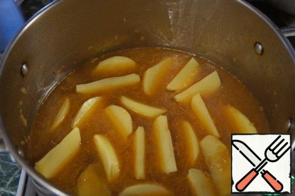 Remove all the meat with a slotted spoon from the pan into a bowl, put the potatoes in the broth, bring to a boil and cook over low heat for 5 minutes.