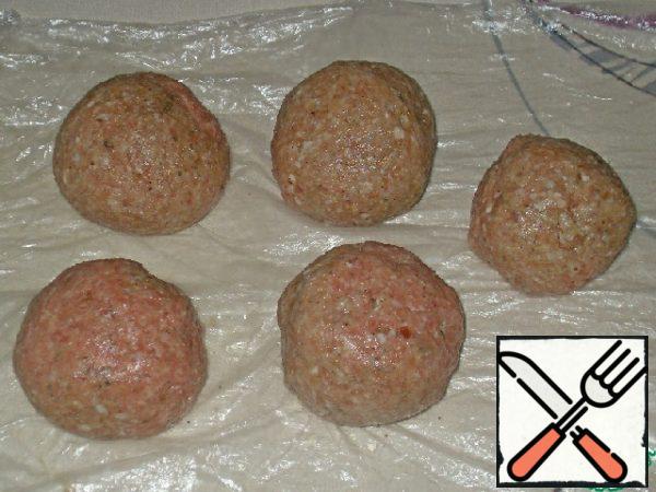 Shape the minced meat into balls and place them on a greased baking sheet,