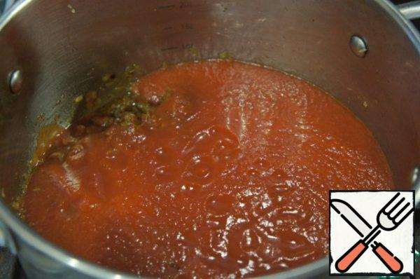 Put the tomatoes (chopped canned or fresh stewed).