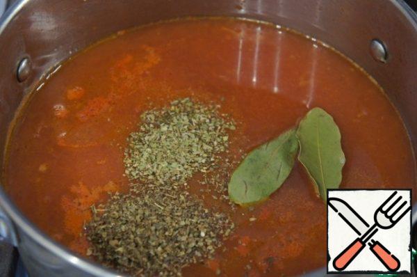 Pour in the broth, add the Basil, oregano and Bay leaf and bring to a boil.