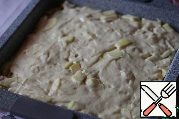 Put the remaining dough on the apples, smooth it out.
Put the mold in the oven, preheated to 180 °, and bake the pie until ready (~ 30-35 minutes).

