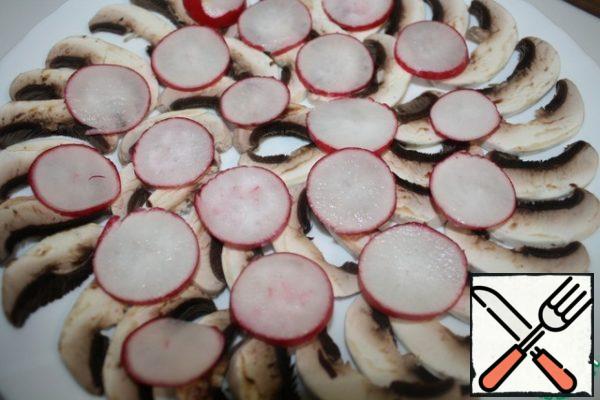 Thinly slice the radishes and put on top of the mushrooms.