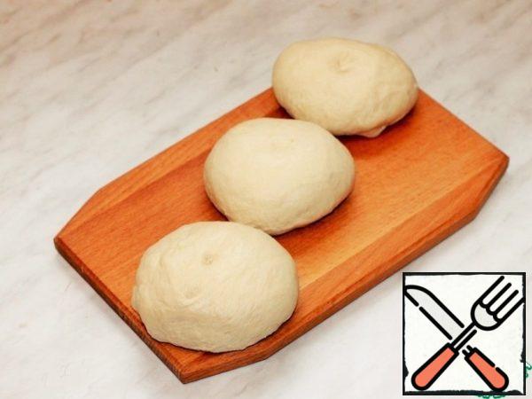 Place the dough on a cutting board and divide into 3 parts.
