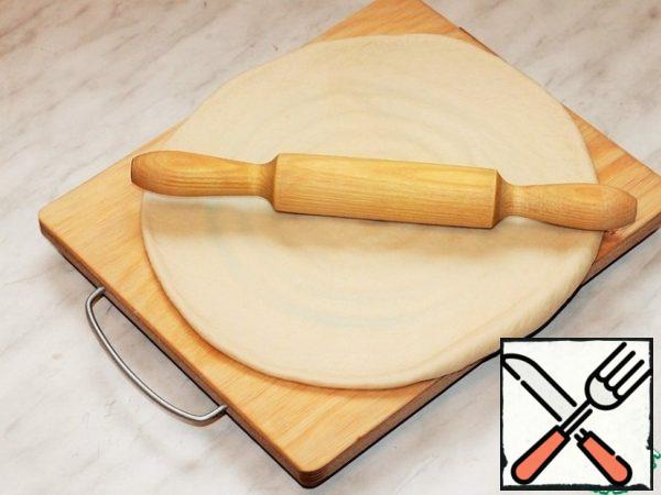 Roll out each part of the dough into a circle.