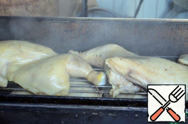 Moisten the alder sawdust with water, let it drain, put it in the smokehouse.
Spread the chicken halves skin up.

