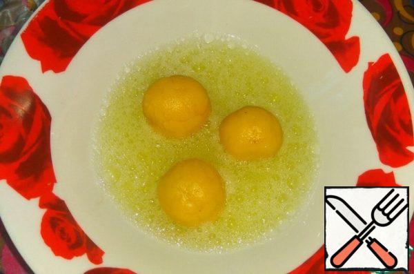 Dip the balls in the egg whites.
