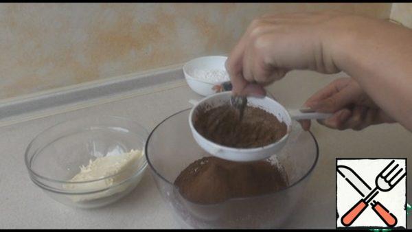 Prepare the dry ingredients: sift flour, starch, cocoa and baking powder. Add salt, mix everything.