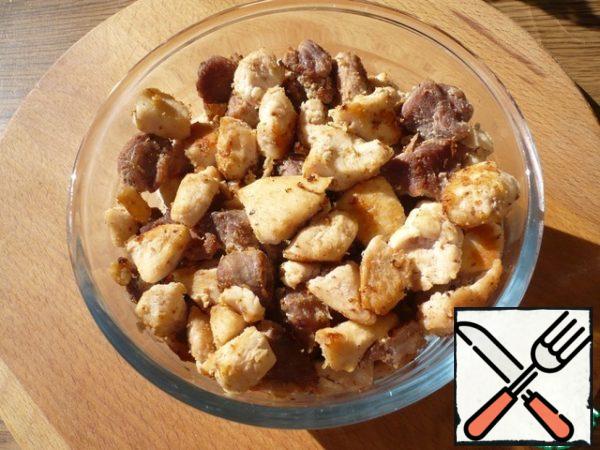The fried meat is transferred to a bowl.
